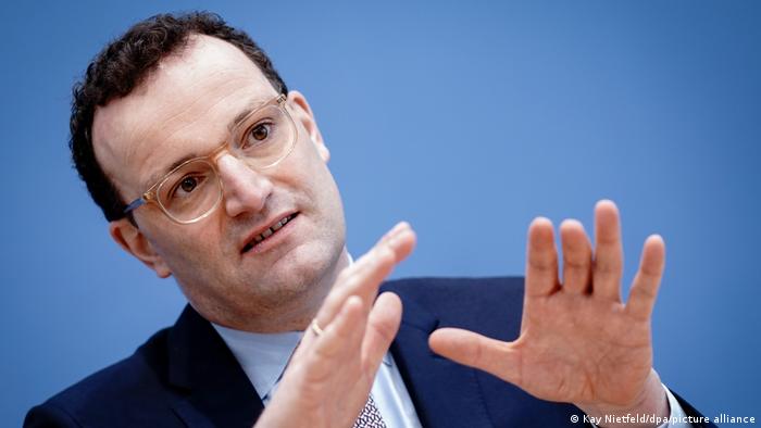 Germany's Health Minister Jens Spahn gestures with both hands during a press conference