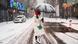 A woman walks through Times Square during a snowstorm A woman walks through Times Square during a snowstorm