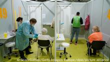 Older people are vaccinated against COVID-19 at a vaccination center in Berlin