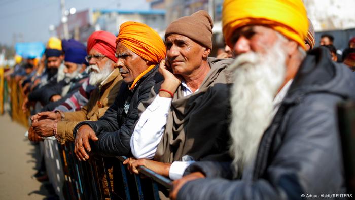 Farmers listen to a speaker during a protest against the farm laws at Singhu border near New Delhi