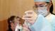 A female hospital worker preparing a Sputnik V injection for a patient A female hospital worker preparing a Sputnik V injection for a patient