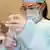 В одной из больниц Минска, врач набирает в шприц вакцину