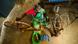 An indian woman in a green sari spins a handloom (seen from above) An indian woman in a green sari spins a handloom (seen from above)