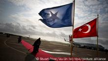 epa02872284 A handout photograph released by the African Union-United Nations Information Support Team (AU-UN IST ) on 19 August 2011 showing a Somali woman sweeping a red carpet at Aden Abdulle International Airport as the flags of Somalia and Turkey flutter in the wind ahead of the arrival of the Turkish Prime Minister Recep Tayyip Erdogan on an official visit to Mogadishu, Somalia on 19 August 2011. Reports state that The Turkish leader is expected to visit camps in Mogadishu housing Internally Displaced People. The visit is intended to encourage other Muslim countries to wake up to the crisis in Somalia and donate emergency aid. EPA/STUART PRICE /AU-UN IST/ HANDOUT HANDOUT EDITORIAL USE ONLY/NO SALES ++ +++ dpa-Bildfunk +++