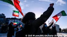 People gesture and wave former flags of Iran as they protest outside the Antwerp criminal court during the trial of four persons including an Iranian diplomate and Belgian-Iranian couple in Antwerp, on February 4, 2021. - A Belgian court returns a verdict on February 4, 2021, in the trial of an Iranian diplomat accused of plotting a bomb attack against opposition activists meeting in France. Assadollah Assadi, a 49-year-old formerly based in Vienna, faces up to 20 years in prison if convicted of plotting to target the June 30, 2018 rally. The gathering in Villepinte outside Paris included senior leaders of the exiled National Council of Resistance in Iran (NCRI) and some high-profile supporters. (Photo by DIRK WAEM / BELGA / AFP) / Belgium OUT (Photo by DIRK WAEM/BELGA/AFP via Getty Images)