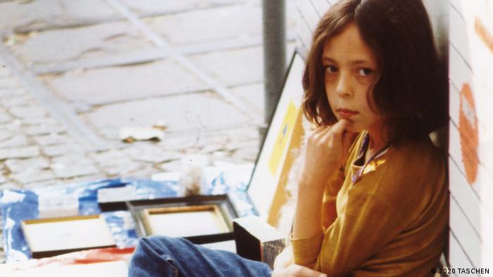 A photo of 9-year-old Taschen selling books on the street.