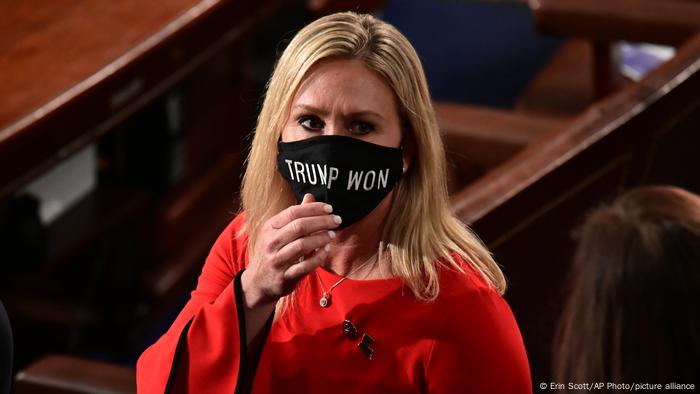 In this Sunday, Jan. 3, 2021, file photo, Rep. Marjorie Taylor Greene, R-Ga., wears a Trump Won face mask as she arrives on the floor of the House to take her oath of office on opening day of the 117th Congress at the U.S. Capitol in Washington.