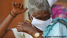 March 21, 2020***
A leprosy affected man, efforts to wear a facemask being distributed by a non-governmental organisation amid concerns over the spread of the COVID-19 novel coronavirus, at Gandhi Leprosy Seva Sangh, a rehabilitation centre for leprosy patients, in Ahmedabad on March 21, 2020. (Photo by SAM PANTHAKY / AFP)