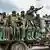 Des soldats congolais assis sur un véhicule militaire dans une zone d'échanges de tirs avec les rebelles ADF dans le Nord-Kivu