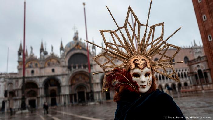 A masked person in St. Mark's Square A masked person in St. Mark's Square