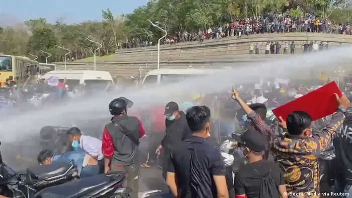 Police firing a water cannon at protests in Naypyitaw