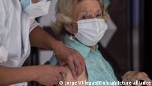 (210204) -- SANTIAGO, Feb. 4, 2021 (Xinhua) -- A senior citizen receives a dose of COVID-19 vaccine from Chinese firm Sinovac in downtown Santiago, Chile, Feb. 3, 2021. Chile on Wednesday launched its mass vaccination campaign against COVID-19, inoculating people over 90 years old at over 1,400 vaccination centers across the country. The campaign is being carried out with almost 4 million vaccines from Chinese firm Sinovac, which arrived aboard two flights last week, while more are to gradually arrive over the coming weeks. (Photo by Jorge Villegas/Xinhua)
