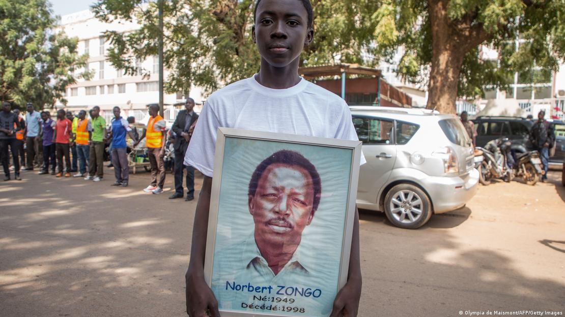 Burkina Faso Un jeune homme tient devant lui un portrait de Norbert Zongo (archive de 2018)