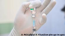 February 9, 2021: Medical staff prepares a syringe with a dose of the Oxford-AstraZeneca vaccine by the Serum Institute of India at the first day of vaccination campaign at Osmani Medical College and Hospital- Vaccination Center , Sylhet, Bangladesh. - ZUMAr143 20210209_zap_r143_003 Copyright: xMdxRafayatxHaquexKhanx