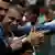 Fans of Bolsonaro making pistol-like hand gestures