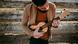 A man plays the ukulele A man plays the ukulele