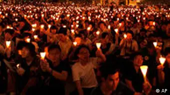 Thousands of people raise candles during a candlelight vigil at Hong Kong's Victoria Park Friday, June 4, 2010, to mark the 21st anniversary of the June 4th military crackdown on the pro-democracy movement in Beijing. (AP Photo/Vincent Yu)