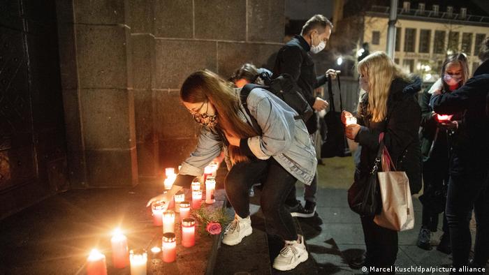 People light candles at the scene of the attack