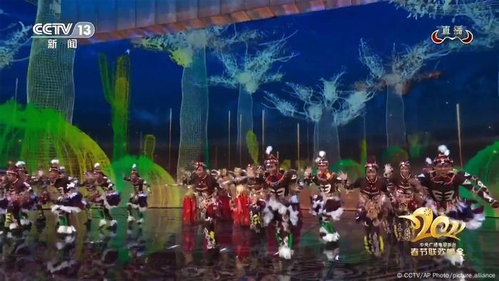 In this image taken from video broadcast by China's CCTV via AP Video, dancers with black faces and costumes representing Africans perform on stage during the Spring Festival Gala.