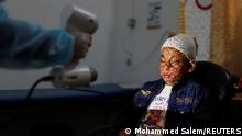 A physiotherapist scans the face of Palestinian boy Ahmed Al-Deeb, who has severe facial burns, to provide him with a 3D transparent face mask, at Medecins Sans Frontieres (MSF)'s clinic in Gaza City February 8, 2021. Picture taken February 8, 2021. REUTERS/Mohammed Salem