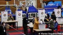 Voters cast their ballots during parliamentary elections in Pristina, Kosovo, February 14, 2021. REUTERS/Florion Goga