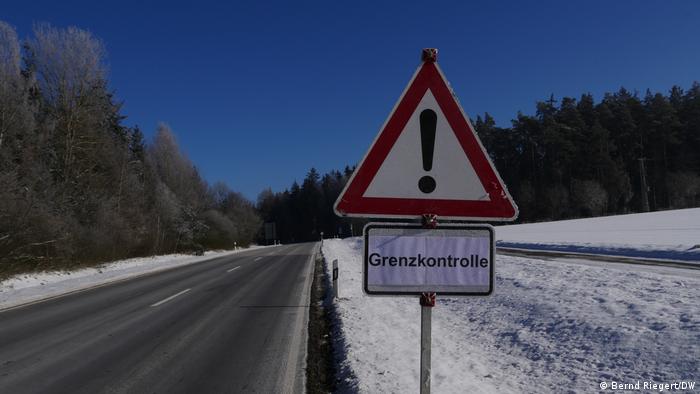 A border control sign in a snowy landscape 