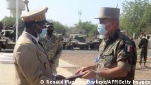 Abakar Abdelkérim (L), chief of general staff of the Chadian army, talks with General Jean-Pierre Perrin (R), commander of the French forces in Gabon, at the handover of ERC 90 Sagaie light armoured vehicles given to Chad by France in N'Djamena, Chad, on January 23, 2021. - France on Saturday handed over nine ERC 90 Sagaie light armoured vehicles to the Chadian army, one of its main partners for regional security and the fight against terrorism in the Sahel, during an official ceremony in N'Djamena. (Photo by Renaud MASBEYE BOYBEYE / AFP) (Photo by RENAUD MASBEYE BOYBEYE/AFP via Getty Images)