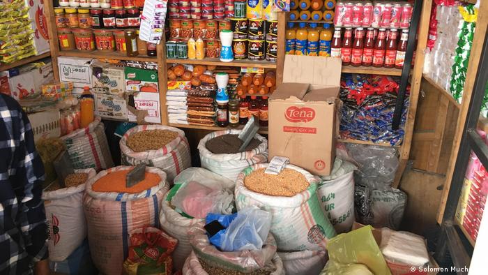 Food commodities such as beans, grains and sauces displayed inside a grocery shop