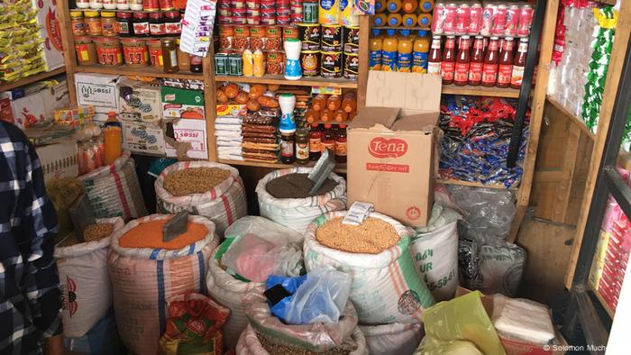 Food commodities such as beans, grains and sauces displayed inside a grocery shop