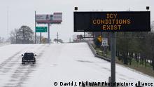 A truck drives past a highway sign Monday, Feb. 15, 2021, in Houston. A frigid blast of winter weather across the U.S. plunged Texas into an unusually icy emergency Monday that knocked out power to more than 2 million people and shut down grocery stores and dangerously snowy roads. (AP Photo/David J. Phillip)
