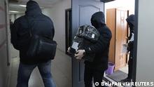 Law enforcement officers leave the office of the independent Belarusian Association of Journalists (BAJ) during a search in Minsk, Belarus February 16, 2021. BelaPAN via REUTERS ATTENTION EDITORS - THIS IMAGE WAS PROVIDED BY A THIRD PARTY. MANDATORY CREDIT.