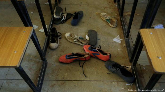 Shoes lying on the floor of a classroom.