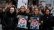 People hold up photos of victims during a march following a vigal outside a shisha cafe in Hanau near Frankfurt am Main, western Germany, on February 21, 2020 People hold up photos of victims during a march following a vigal outside a shisha cafe in Hanau near Frankfurt am Main, western Germany, on February 21, 2020