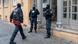 Police in one of the raids, one carrying a pair of bolt cutters Police in one of the raids, one carrying a pair of bolt cutters