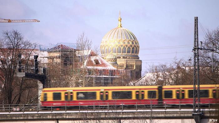 Berlin's Neue Synagoge in the background with a passing train in the foreground