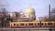 Berlin's Neue Synagoge in the background with a passing train in the foreground Berlin's Neue Synagoge in the background with a passing train in the foreground