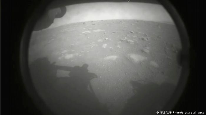 This photo made available by NASA shows the first image sent by the Perseverance rover showing the surface of Mars, just after landing in the Jezero crater