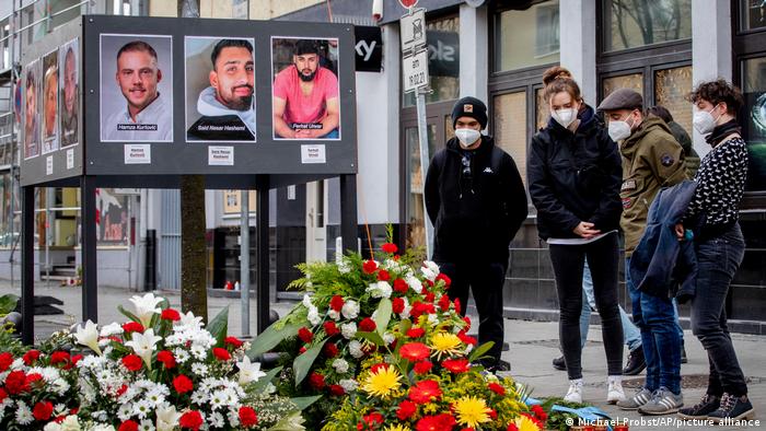 People lay flowers for the victims of the Hanau shooting on Friday