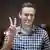  Alexei Navalny makes a peace sign while in court in Moscow, Russia