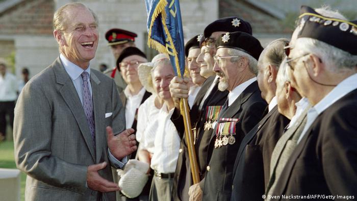 Prince Philip, Duke of Edinburgh, bursts out in laughter during a conversation with WW II veterans