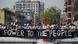 Demonstrators standing behind a banner saying 'Power to the people' in Yangon, Myanmar Demonstrators standing behind a banner saying 'Power to the people' in Yangon, Myanmar