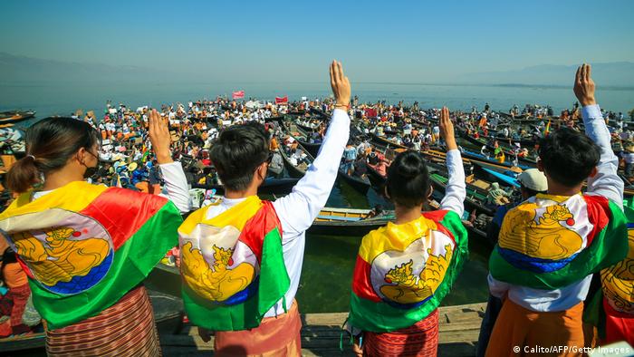 Children wearing a Shan flag give a three finger salute