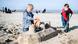 Picture of two children building a sandcastle on a beach Picture of two children building a sandcastle on a beach