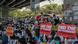 Protesters hold signs reading 'end the dictatorship' as they gather in Yangon Protesters hold signs reading 'end the dictatorship' as they gather in Yangon