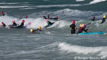 Junior lifesavers swim at Fish Hoek beach, a popular swimming and surfing spot in Cape Town on November 17, 2020. - Fish Hoek has, in the past, been the site of shark attacks. (Photo by RODGER BOSCH / AFP)