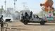 Niger's anti-riot police officers arrive in a street with smoke and projectiles on the ground Niger's anti-riot police officers arrive in a street with smoke and projectiles on the ground