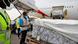 A man incpects a shipment that has been unloaded from a plane A man incpects a shipment that has been unloaded from a plane