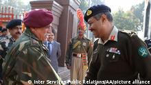 Pakistani Director General of Military Operations (DGMO) Major General Aamer Riaz (R) shakes hands with his Indian counterpart Lieutenant General Vinod Bhatia upon his arrival on the Pakistan-India Wagah Border on December 24, 2013. The meeting -- the first in 14 years -- between the director generals of military operations (DGMOs) of Pakistan and India was held at Wagah border Lahore in a bid to strengthen an otherwise fragile ceasefire between the two nuclear rivals on border along Kashmir. Pakistan Inter Services Public Relations (ISPR) / Anadolu Agency