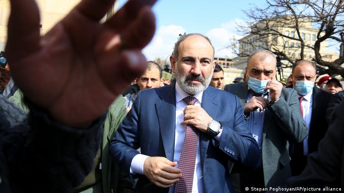 Armenian Prime Minister Nikol Pashinyan fixes his tie ahead of a rally in Yerevan