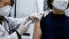 A health care worker injects a woman with a coronavirus vaccine A health care worker injects a woman with a coronavirus vaccine